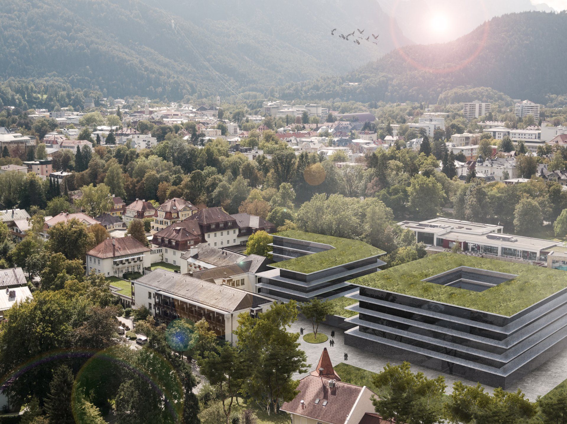 Eine Luftaufnahme einer Stadt mit Bergen im Hintergrund