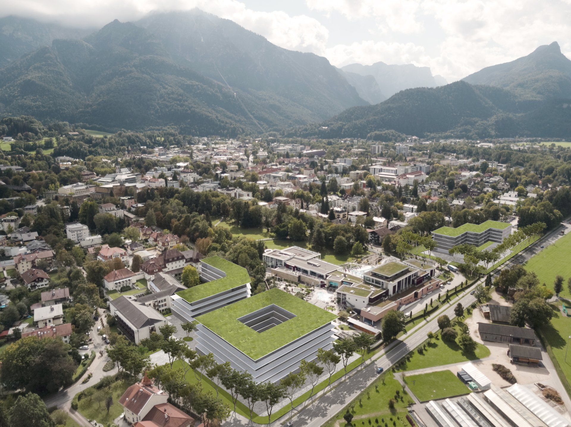 Eine Luftaufnahme einer Stadt mit Bergen im Hintergrund