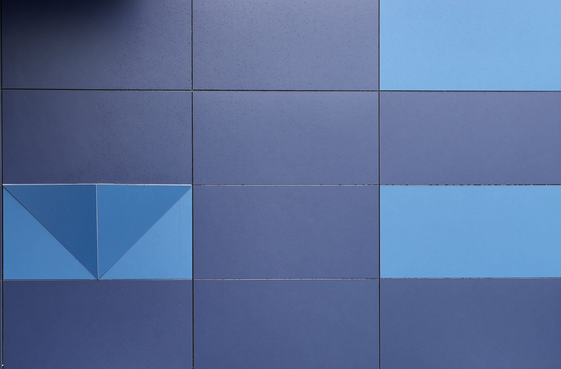 Eine blaue Fliesenwand mit einem Dreieck in der Mitte