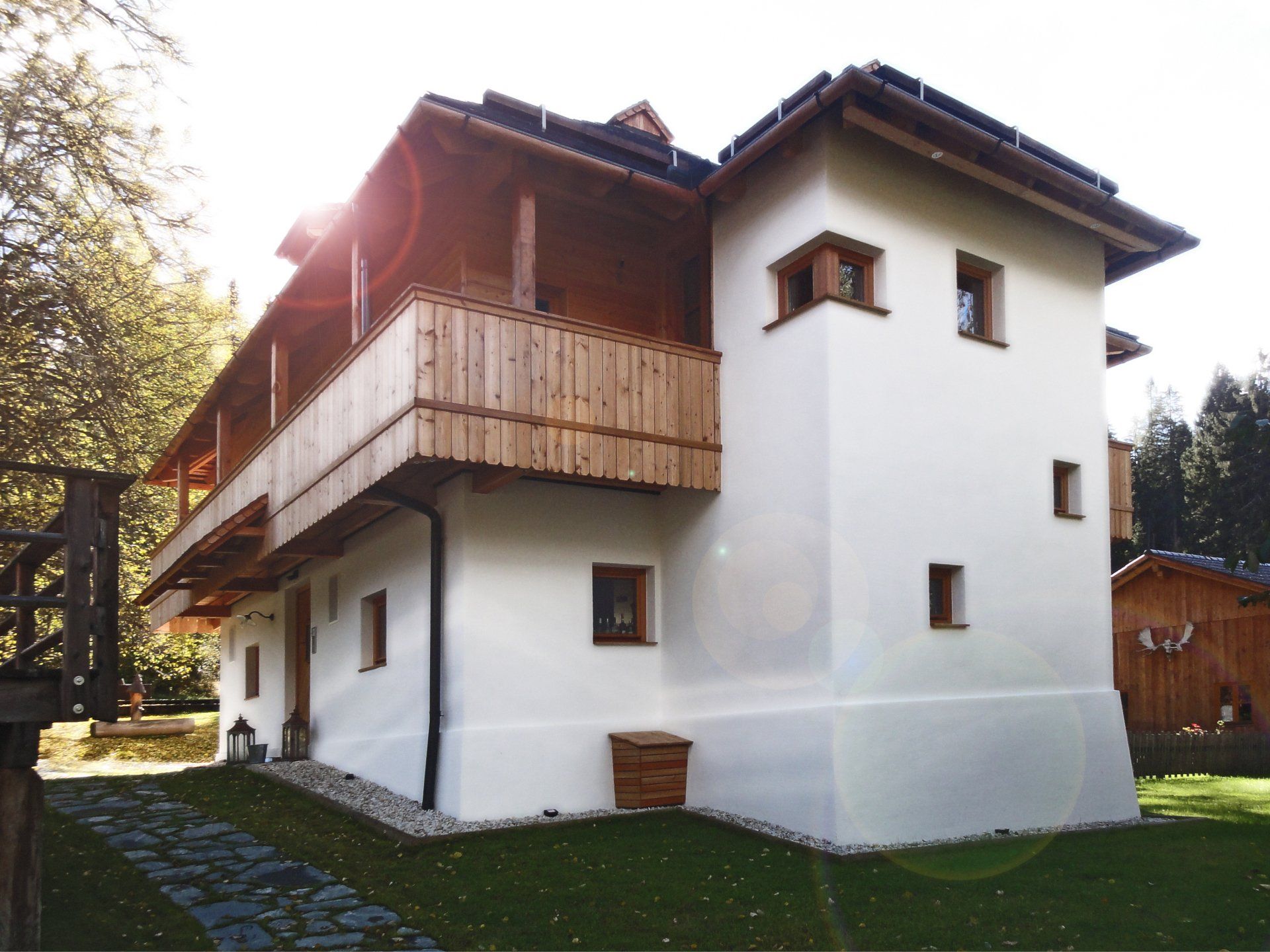 Ein großes weißes Haus mit einem Holzbalkon