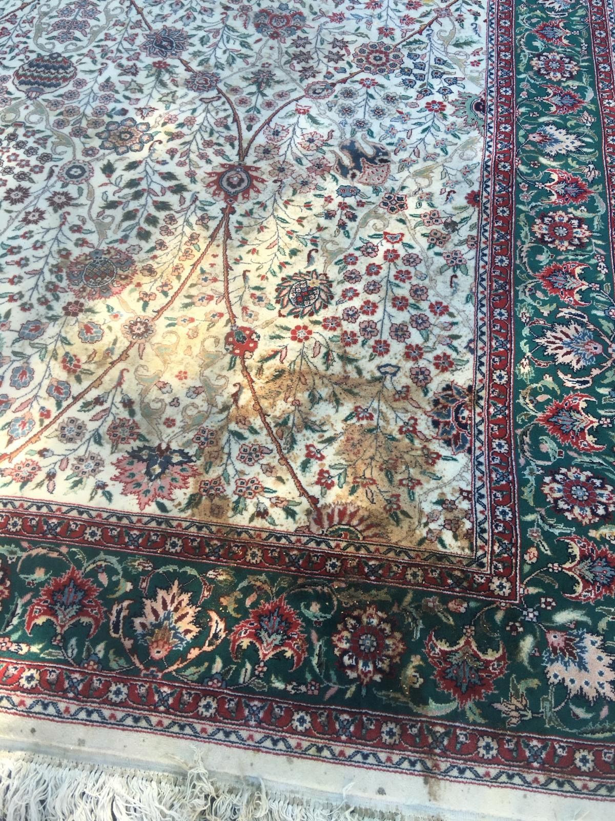 A close up of a rug with a floral pattern on it.