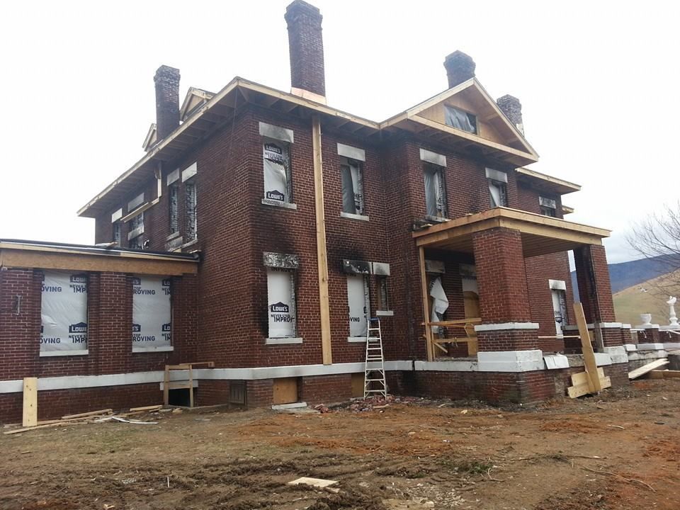 A large brick building under construction with a lot of windows