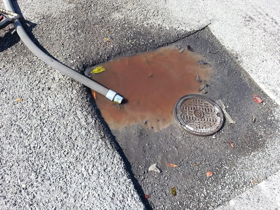 A rusty manhole cover with the number 35 on it