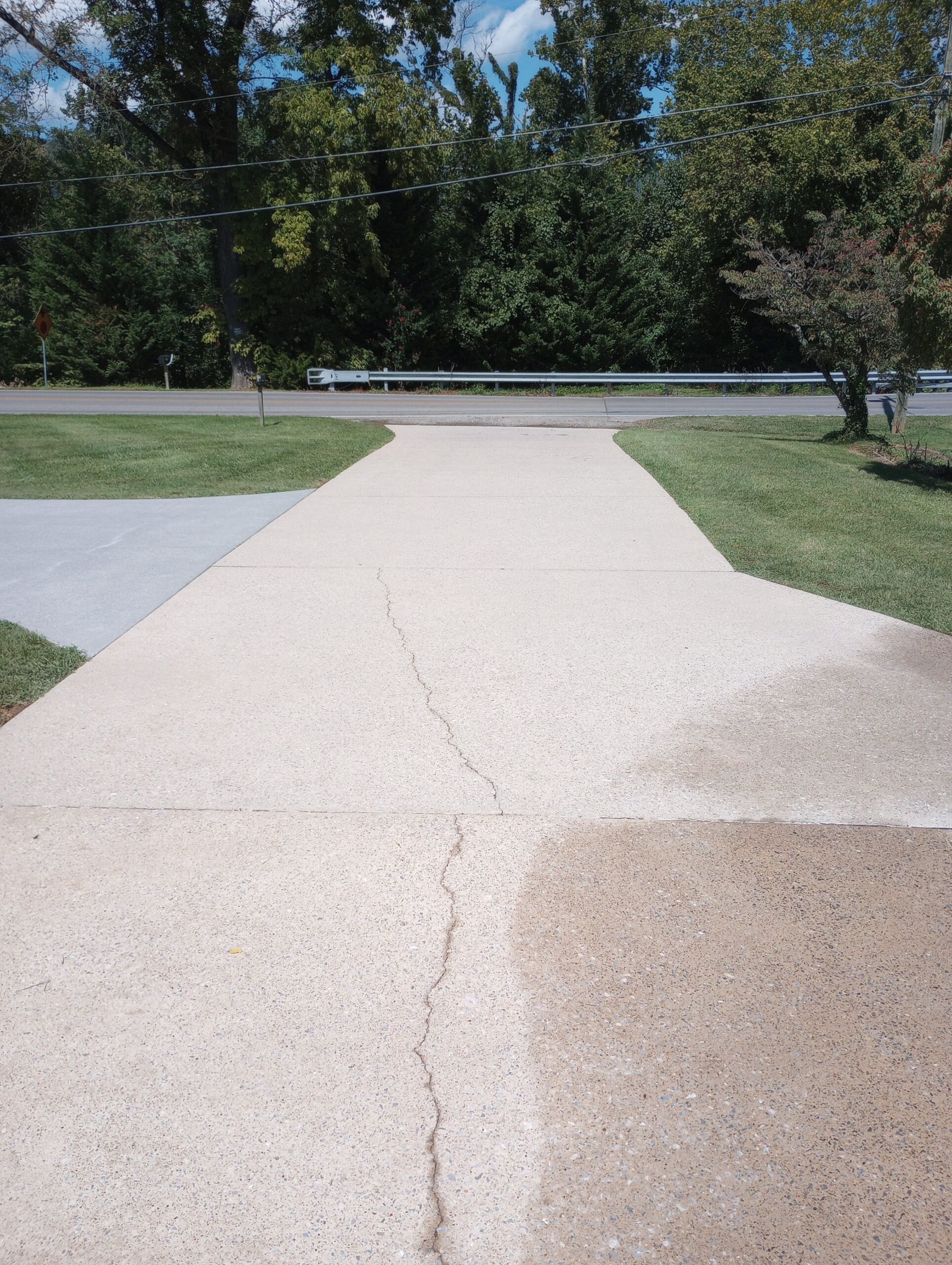 A before and after picture of a concrete driveway.