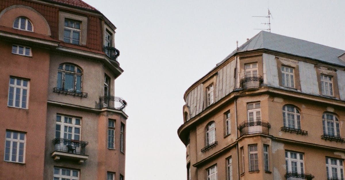 A couple of buildings with balconies on the side of them.