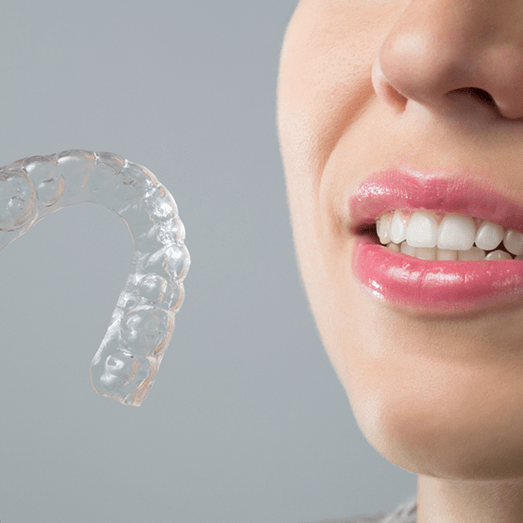 woman holding an Invisalign