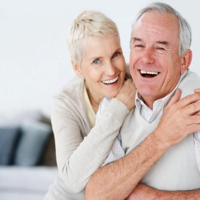 old couple laughing using dentures