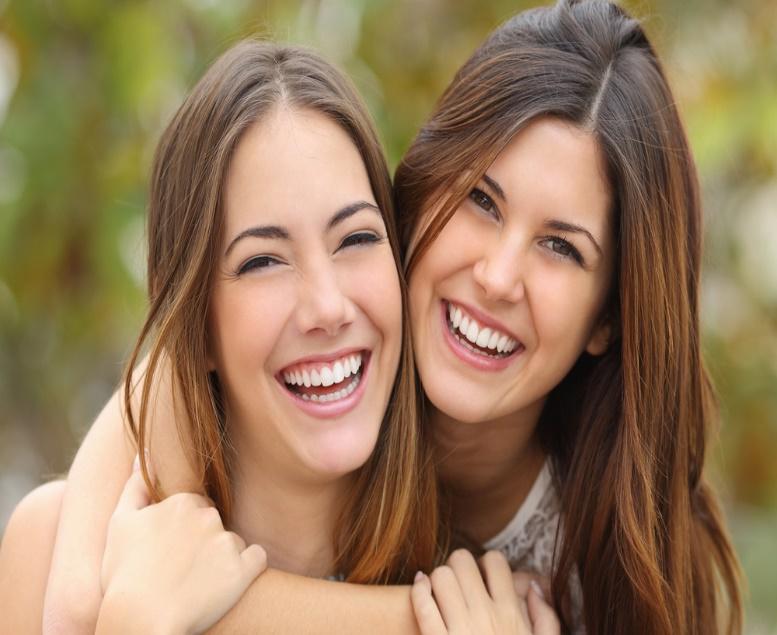 young laughing girls with white teeth