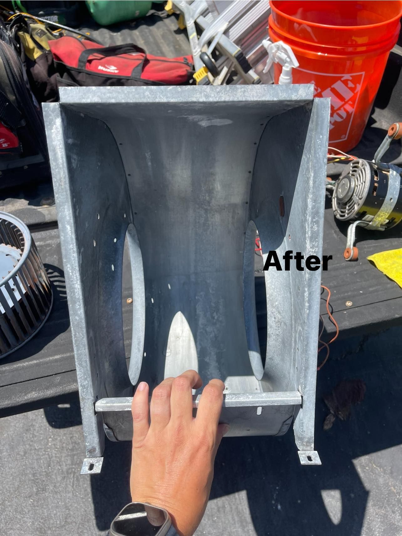 Hand holds metal ductwork, 