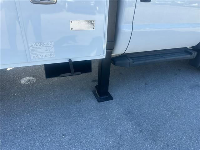 A white truck is parked on the side of the road