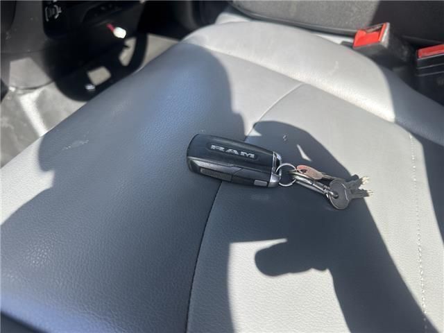 A ram car key is on the seat of a car