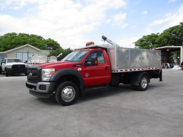 A red truck is parked in a parking lot