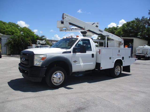 A white utility truck is parked in a parking lot