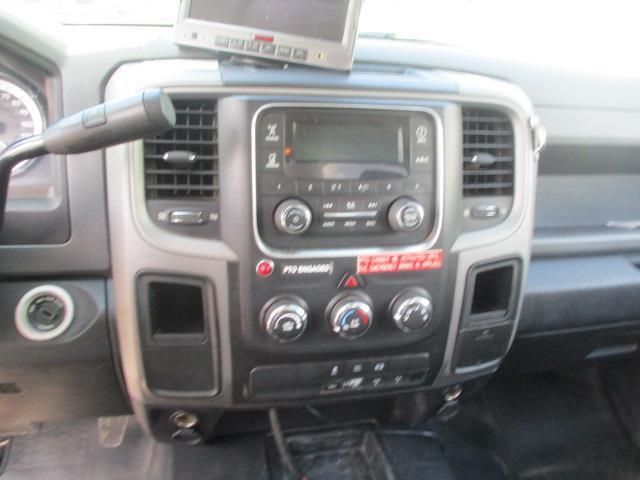 The dashboard of a dodge ram truck with a microphone on top of it.