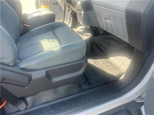 A close up of the seats in a car with the door open.