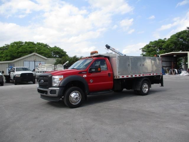 A red truck is parked in a parking lot
