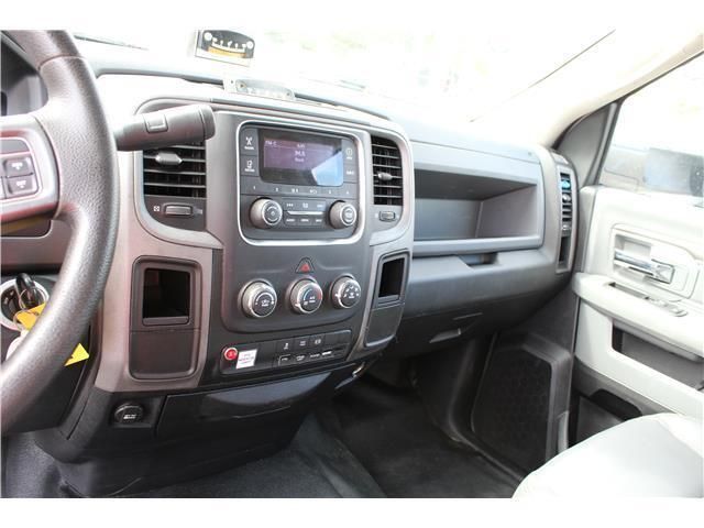 The interior of a dodge ram truck with a radio and steering wheel.