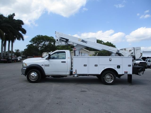 A white utility truck is parked in a parking lot