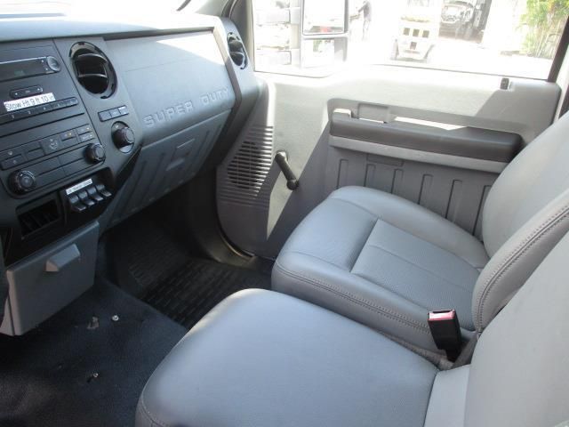 The interior of a ford truck with gray leather seats