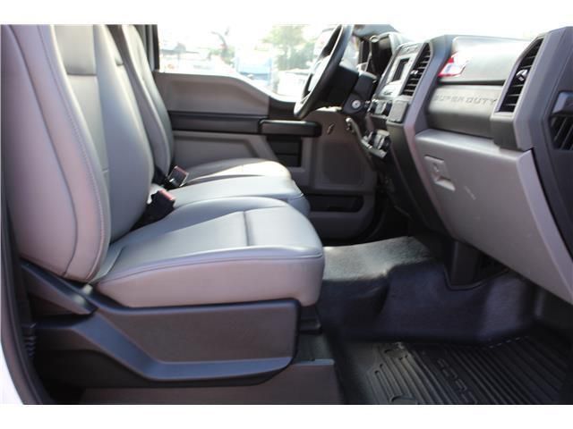 The interior of a white truck with grey seats