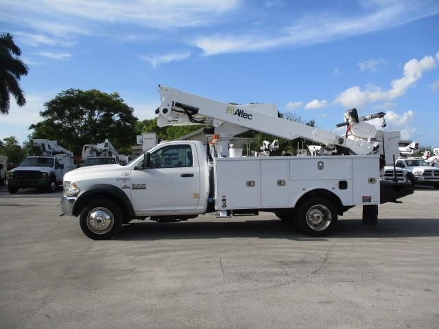 A white utility truck is parked in a parking lot