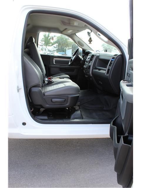 The inside of a white truck with the door open