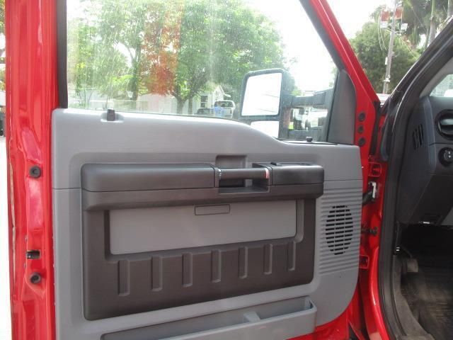 The inside of a red truck with the door open.