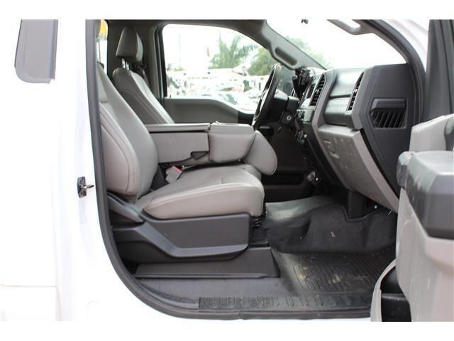 The interior of a white truck with the door open