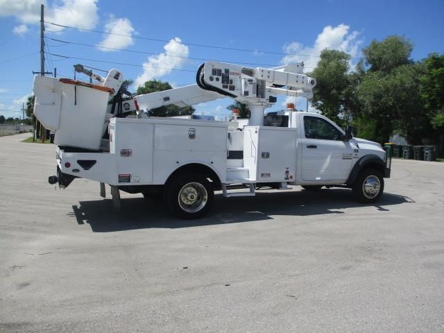 A white utility truck is parked in a parking lot