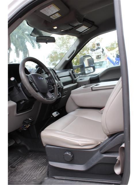 The interior of a ford truck with the door open
