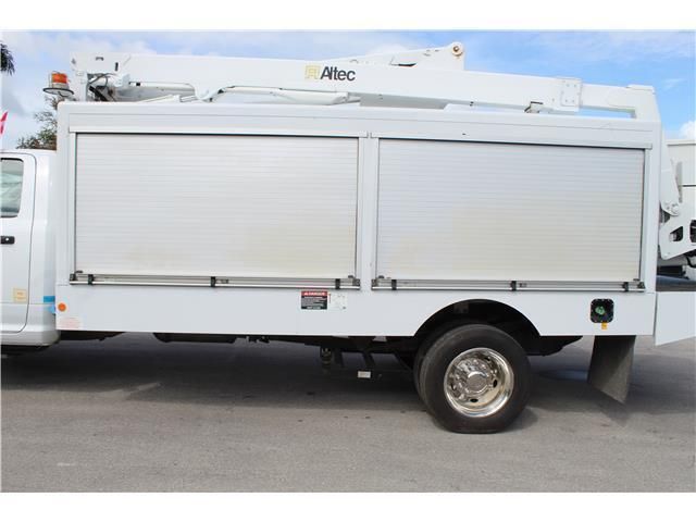 A white truck with a crane on top of it