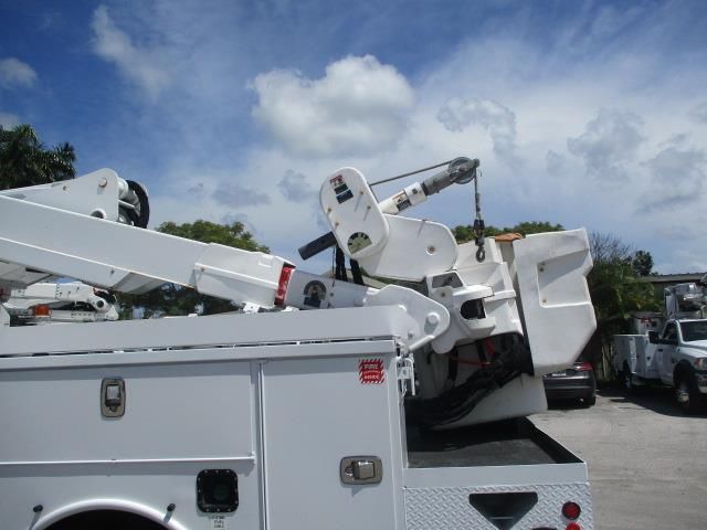 A white utility truck with a crane attached to it