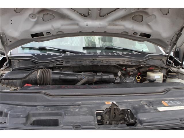 A close up of a car engine with the hood open