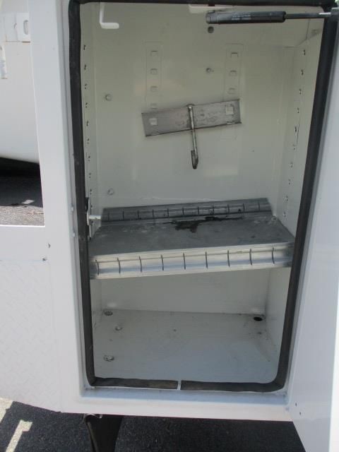 A white box with a shelf inside of it