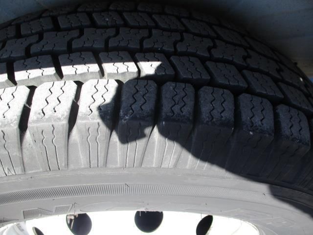 A close up of a tire with a shadow on it