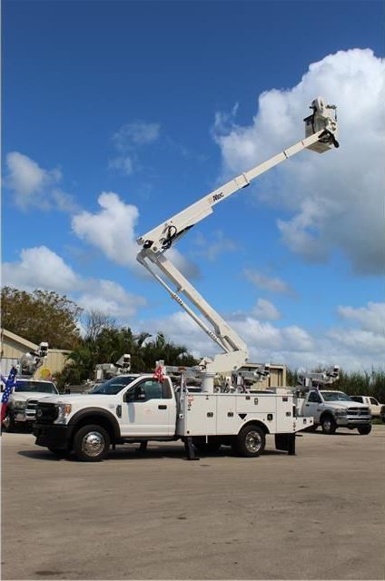 A white truck with a bucket on top of it