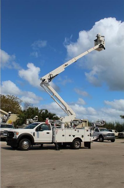 A white truck with a bucket on top of it