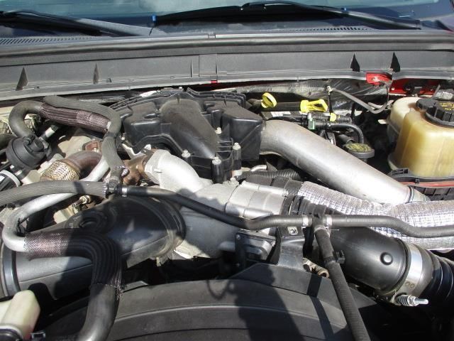 A close up of a car engine with the hood open