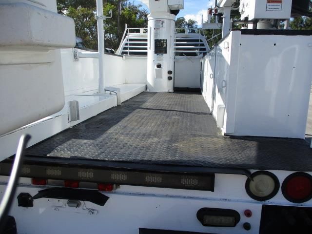 A white truck with a black mat on the floor