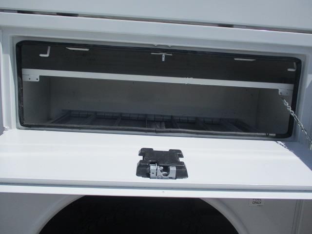 The back of a white truck with the door open