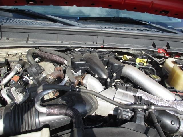 A close up of a car engine with the hood up