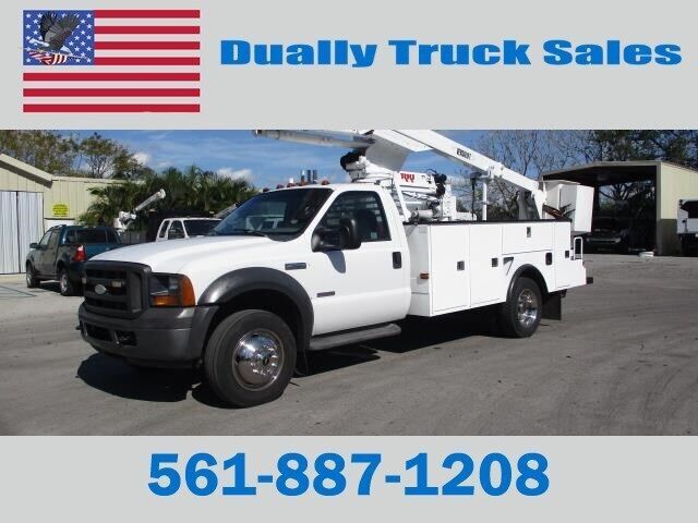 A white truck with a crane on the back is for sale by dually truck sales