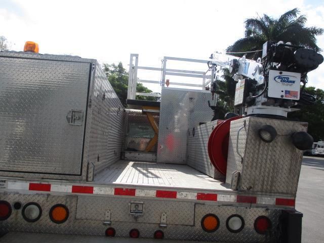 A silver truck with a crane on top of it