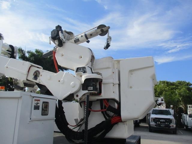 A white truck with a crane attached to it