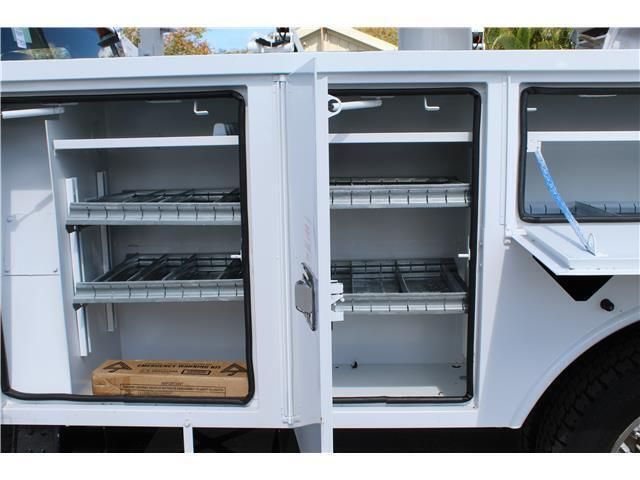 A white truck with the doors open and shelves