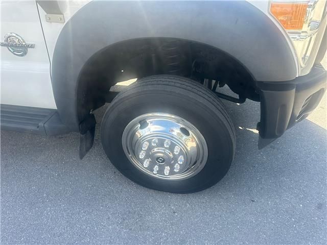 A white truck is parked on the side of the road.