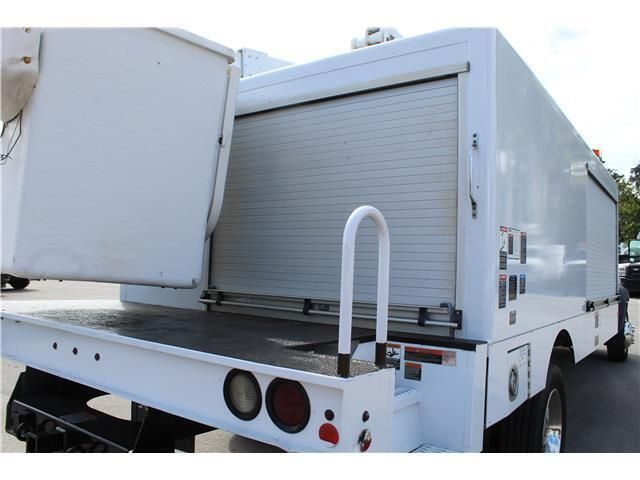 A white truck with a ladder on the back of it