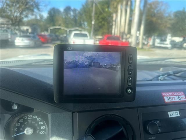 A rear view camera is mounted on the dashboard of a truck.