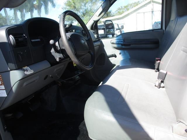 The interior of a truck with a steering wheel and seats