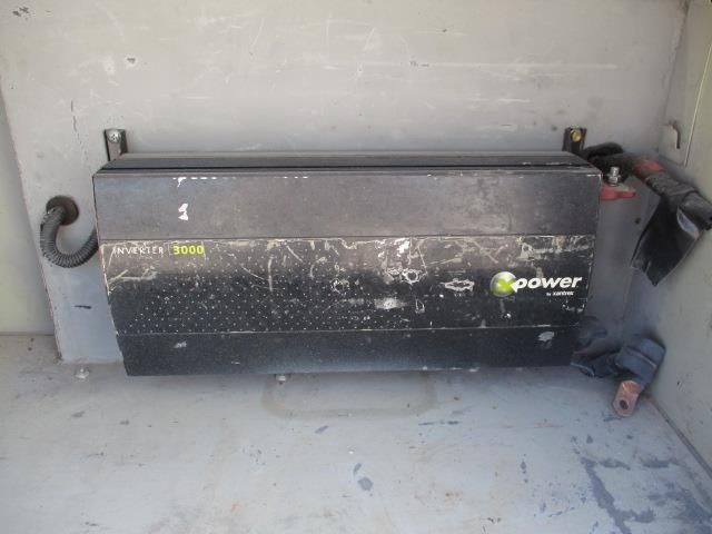 A black box with the word power on it is sitting on the floor.